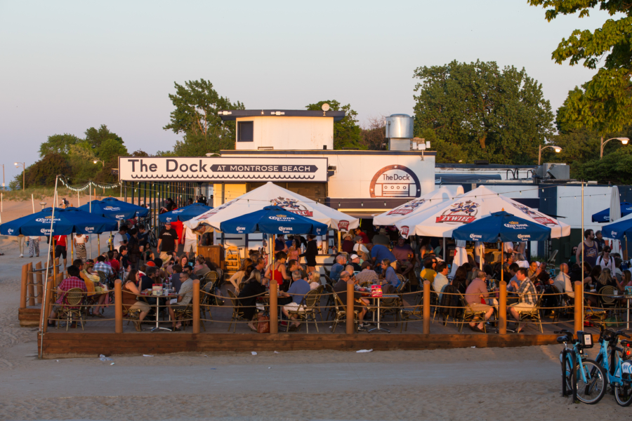 Diners enjoy the patio at The Dock as the sun sets at Montrose Beach in Chicago.