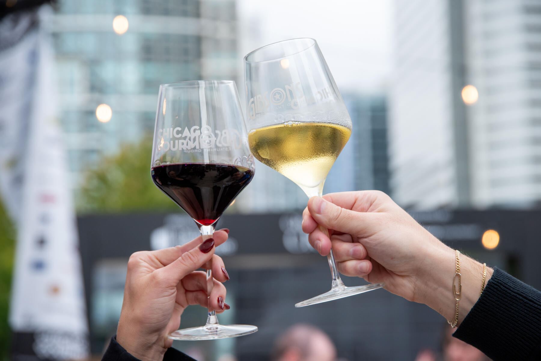 Friends clink wine glasses at Chicago Gourmet