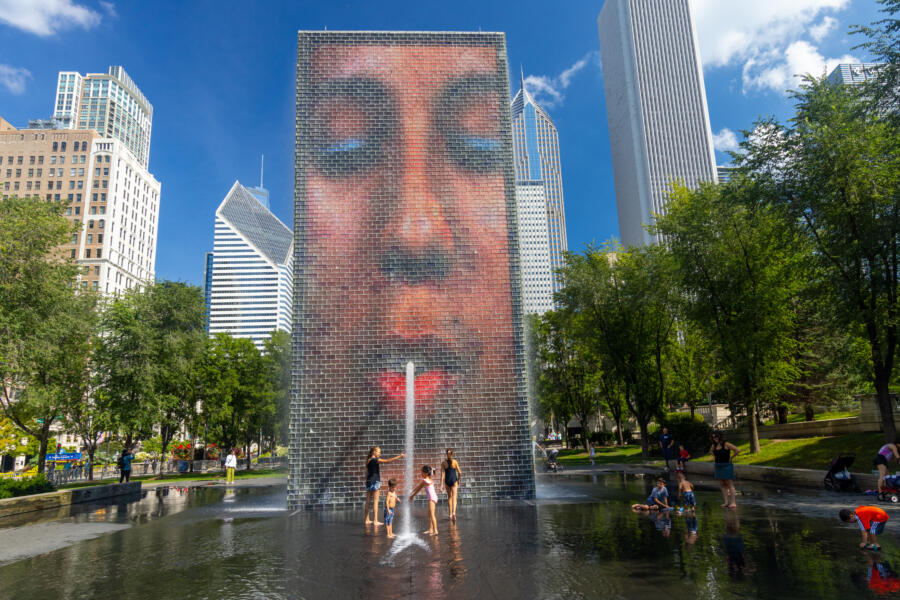 Kids play at Crown Fountain in Millennium Park on a sunny day